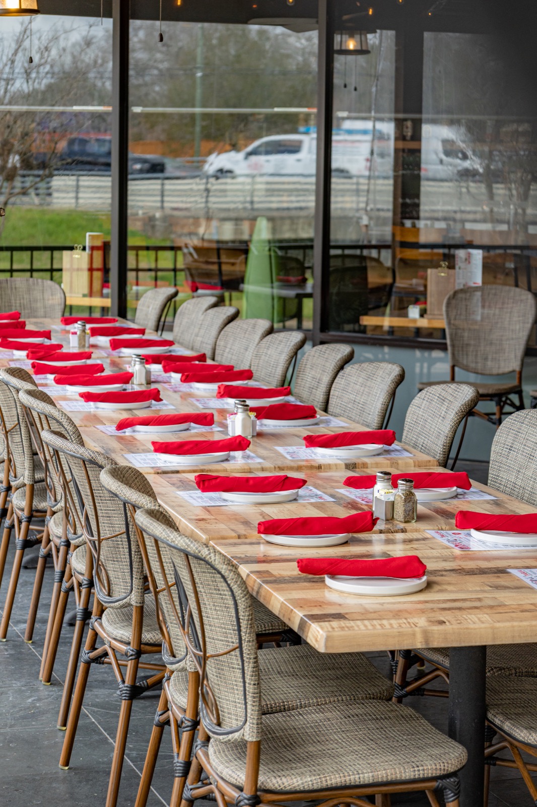 A long Taglia table set with red napkins